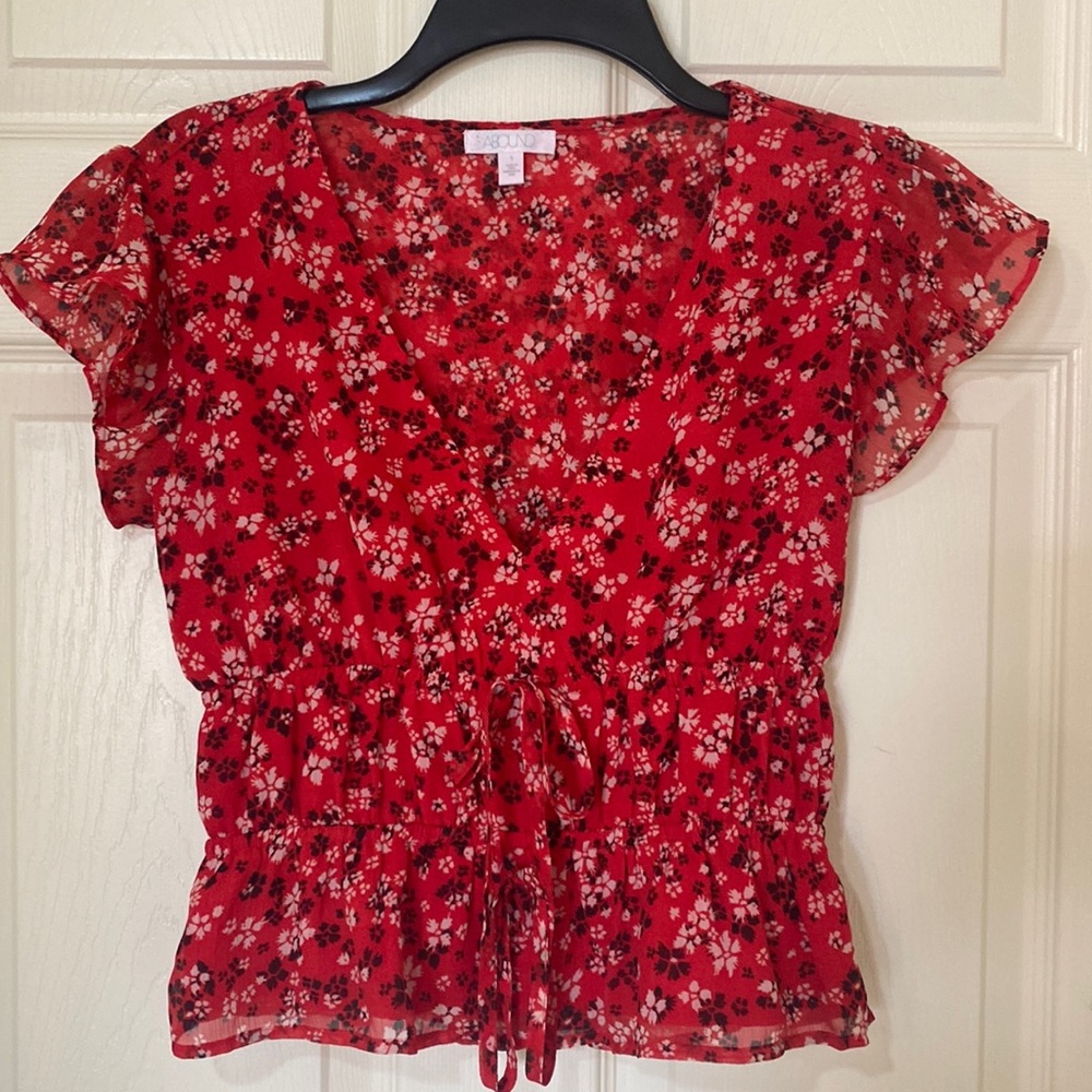 Abound top with ruffle sleeves, deep v-neck and double ties